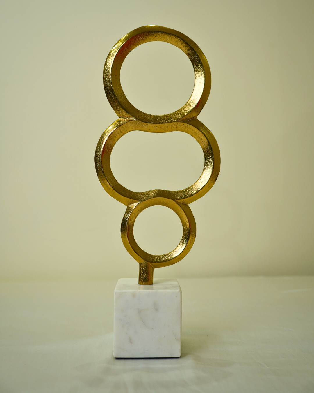 Abstract Golden Metal Triple Ring Sculpture with Marble Base